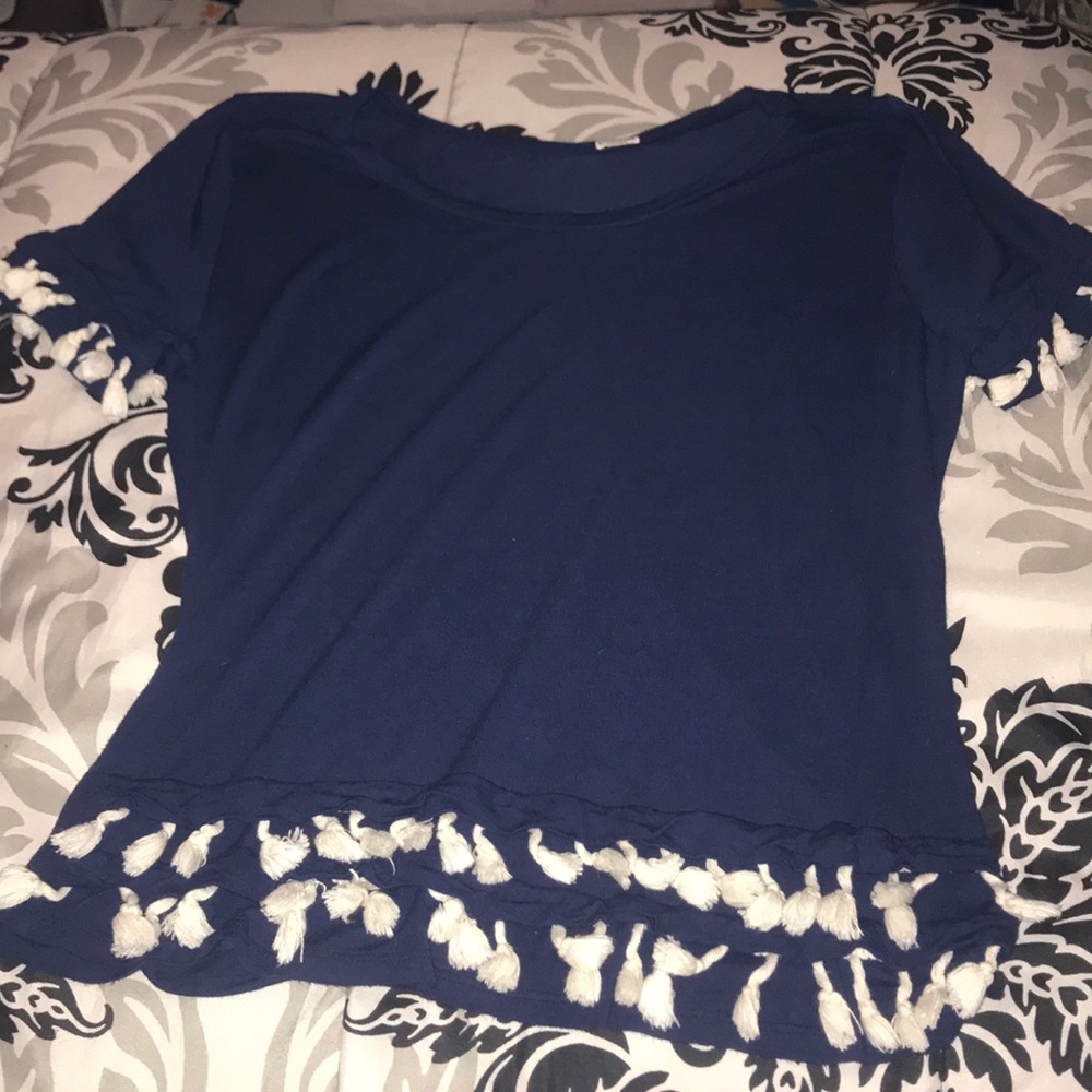 blue shirt with white tassels